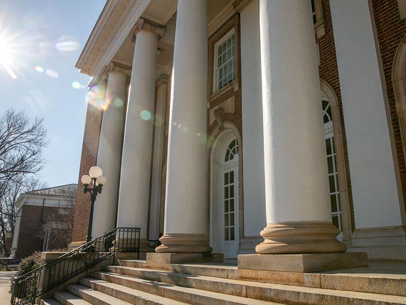 image of building with tall columns and sunspot