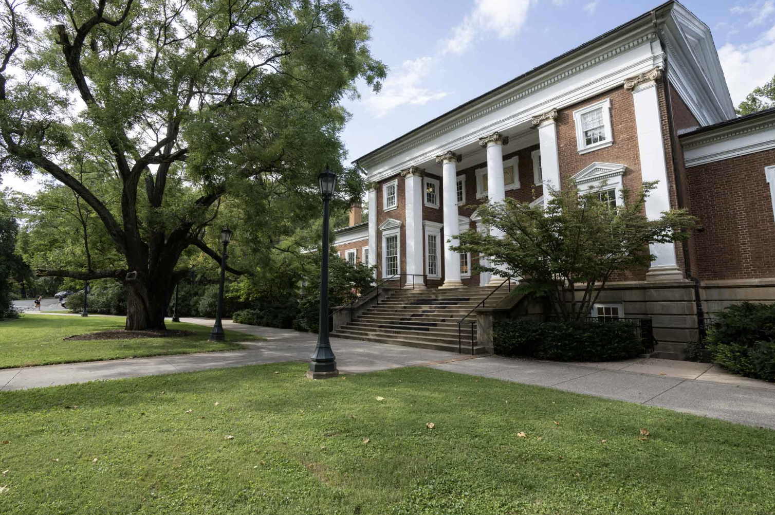 Image of academic building with trees and sidewalk