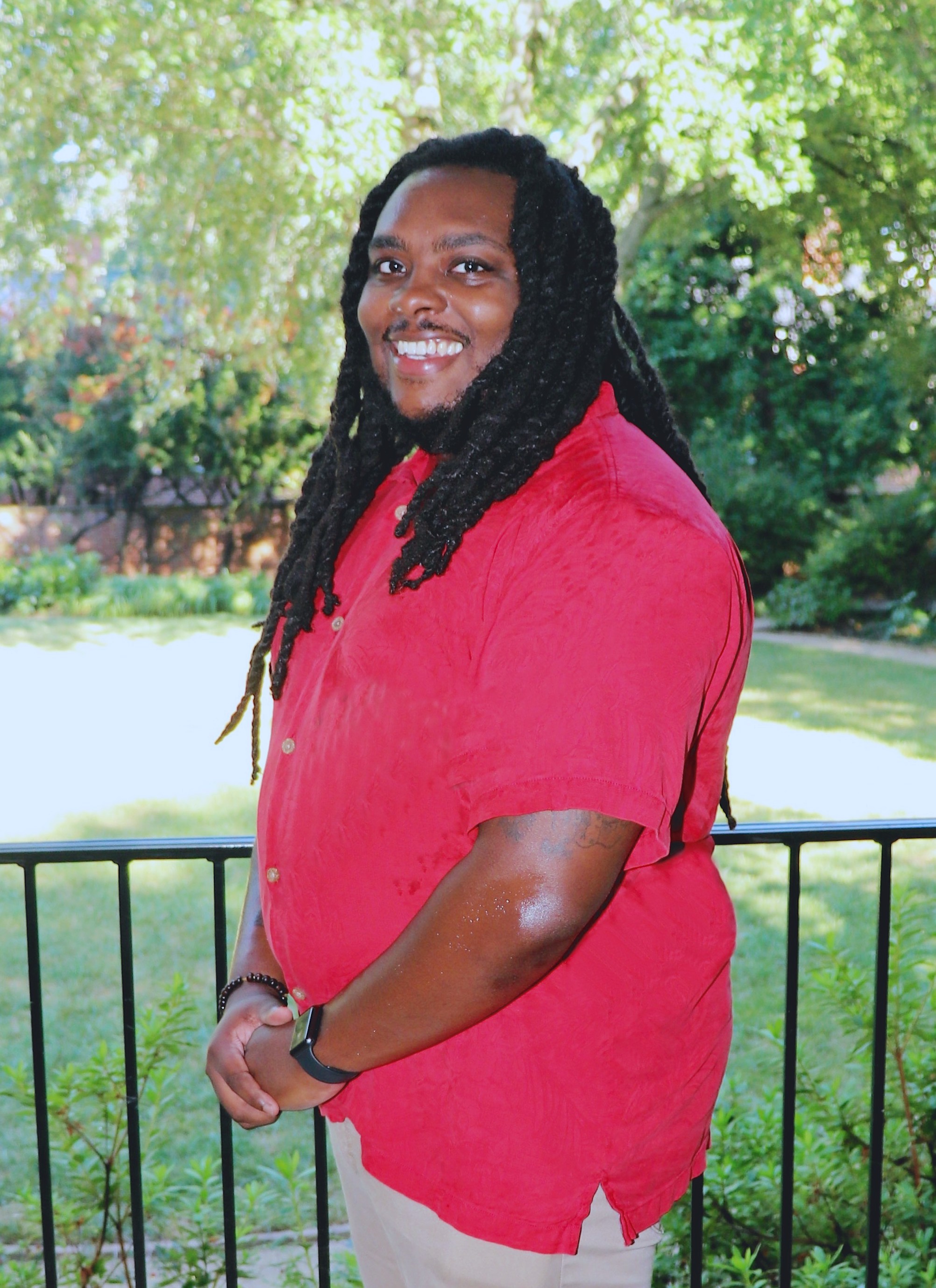 Man in red shirt with arms folded