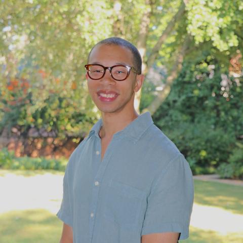 Man in glasses with arms folded
