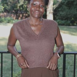 Woman leaning with elbows on a metal fence