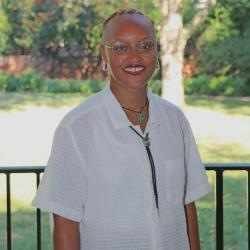 Headshot of person in white shirt with glasses